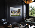 A framed art print depicting a vintage outdoor scene with people, displayed on a dark paneled wall in a modern, stylishly decorated living room with a black leather lounge chair and a green sofa.