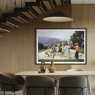 A framed art print depicting a retro poolside scene with people and a camel, displayed on a slatted wood wall in a modern dining room setting.