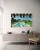 Framed artwork of a pool scene on a wall above a modern cabinet.