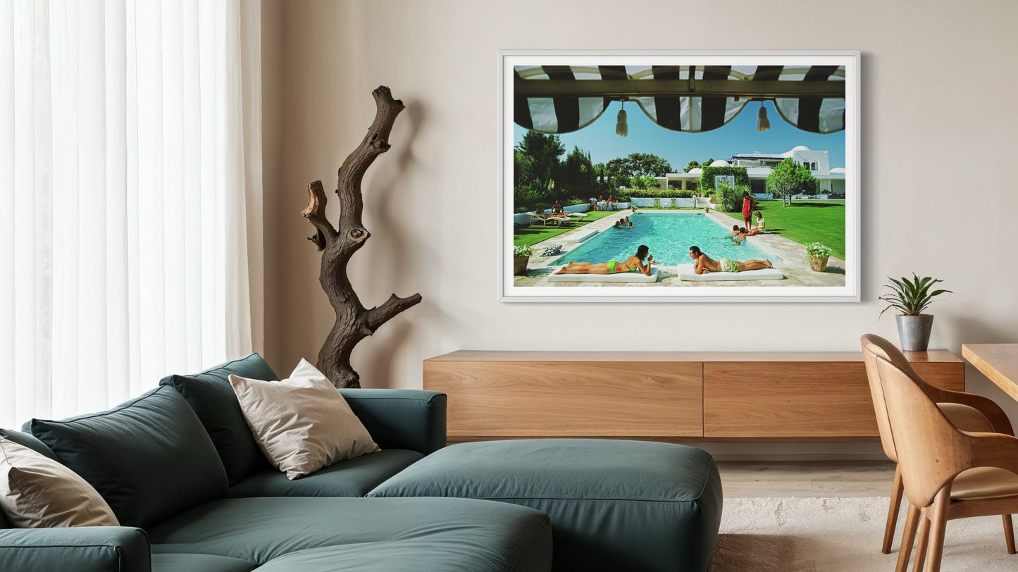 Living room with a large framed picture of a pool scene on the wall.