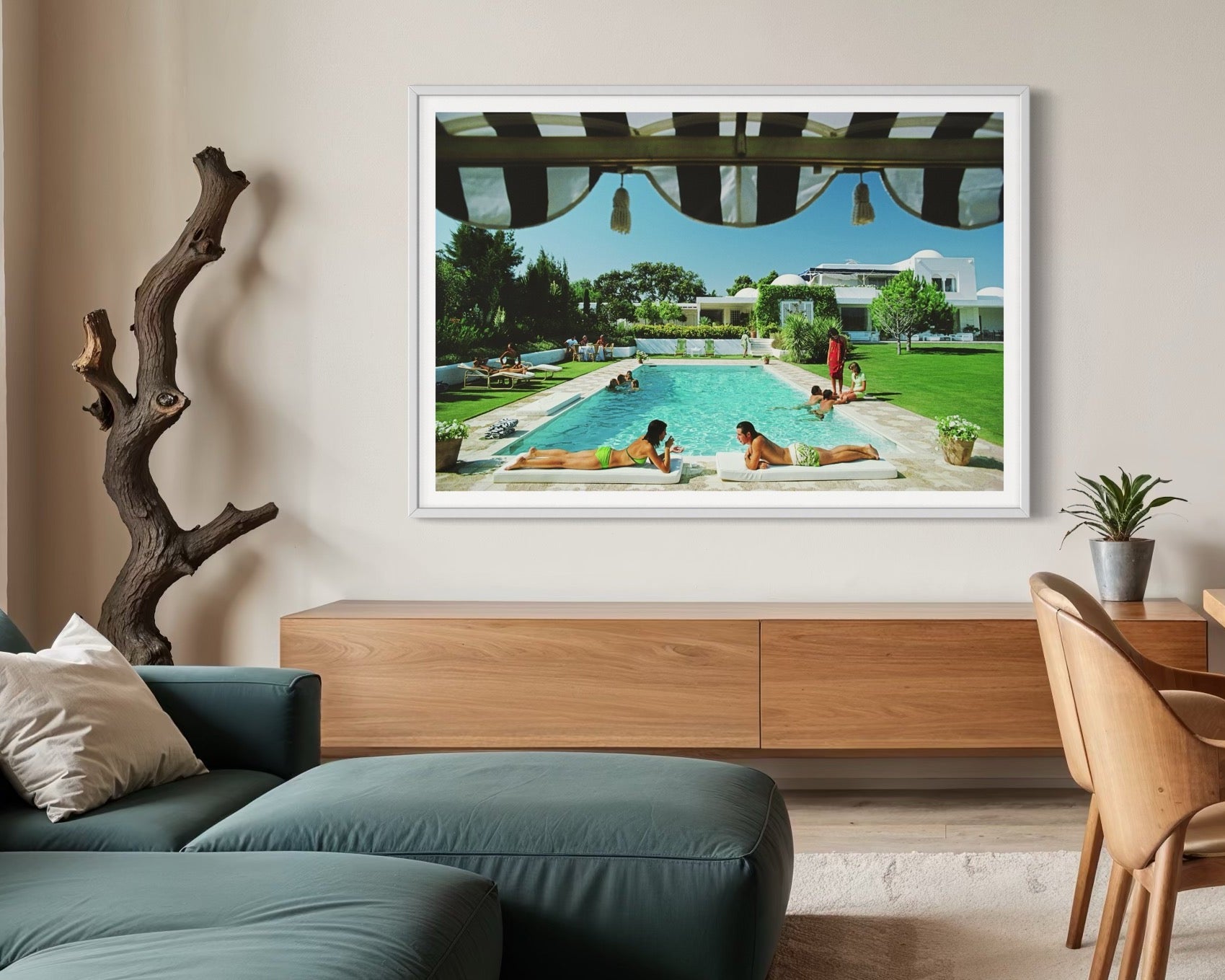 Living room with a large framed picture of a pool scene on the wall.