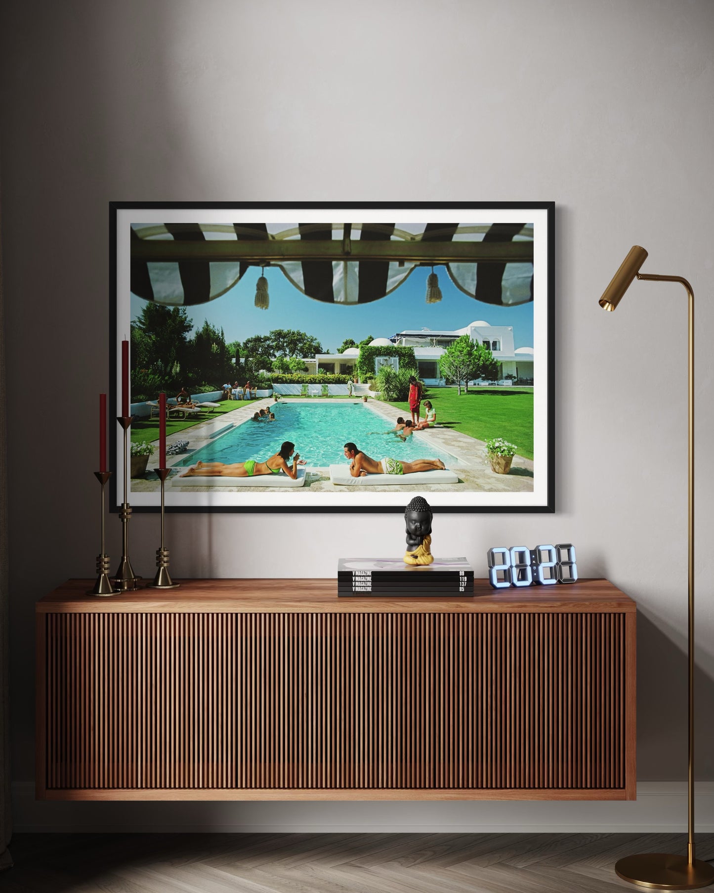Framed artwork of a pool scene on a wall above a wooden cabinet.