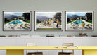 A set of three framed art prints depicting poolside scenes with people, displayed on a gray wall above a white cabinet and a yellow table.