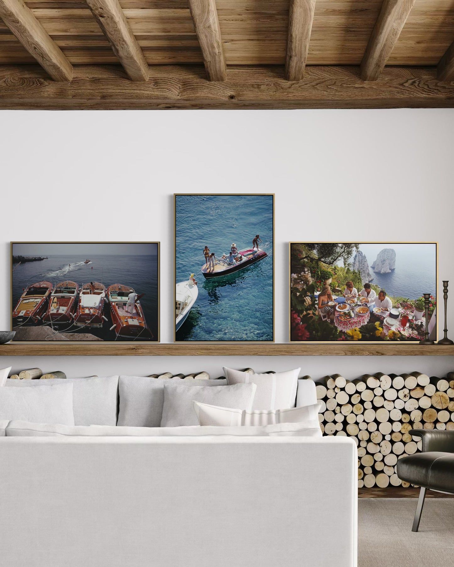 Living room with framed photographs of boats and people on a wall.