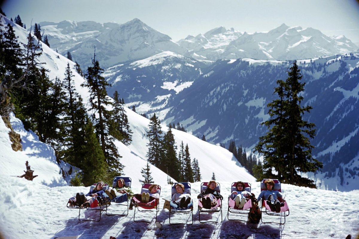 Lounging in Gstaad by Slim Aarons, a classic luxury lifestyle ski photograph offered by The Picturalist as fine art prints USA and framed prints Canada, ideal for luxury art procurement, bespoke wall art solutions, and high-end interior design art for chalets, hotels, and contemporary homes.