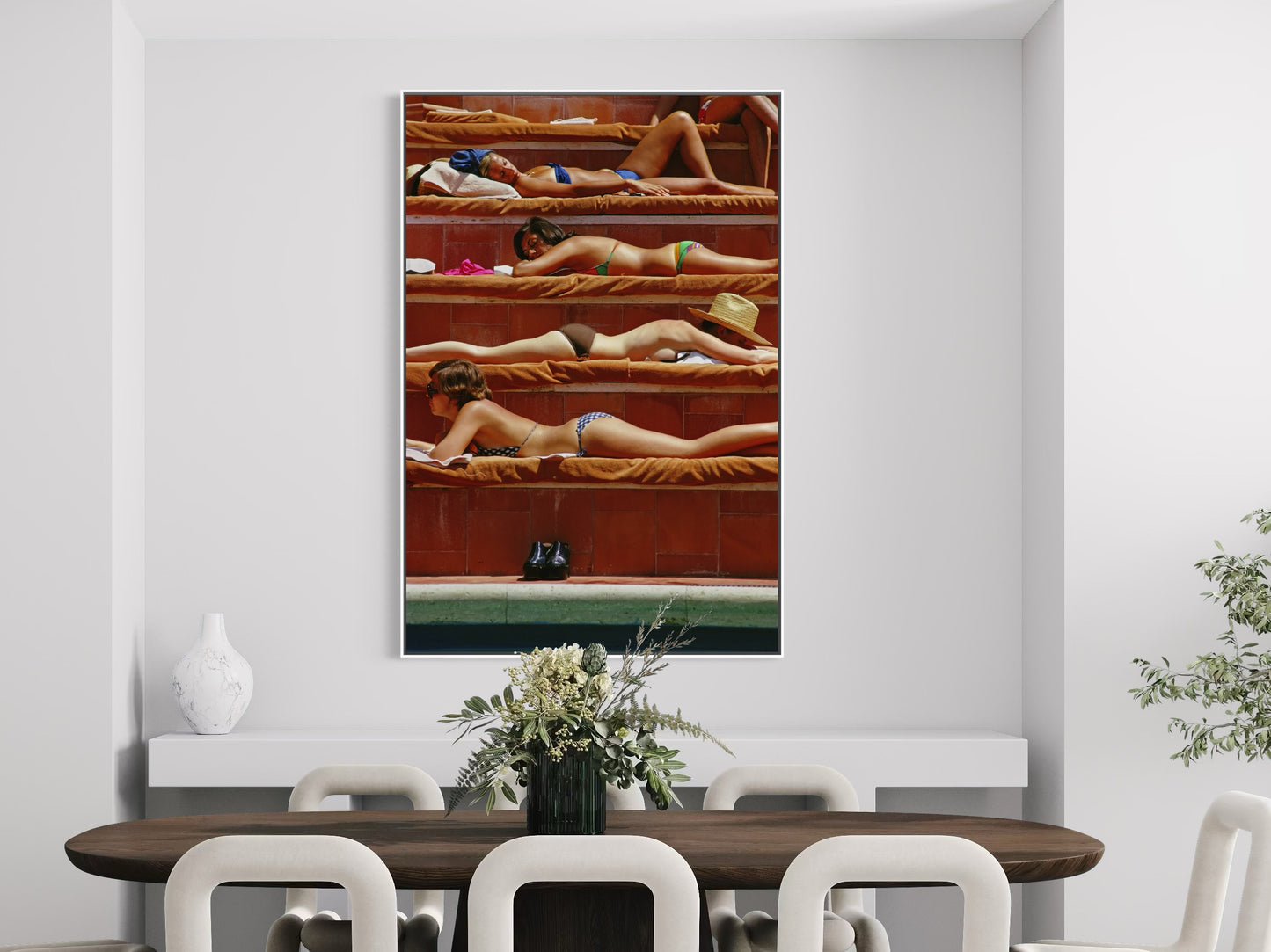 Dining room with a large painting of people in a pool on the wall.