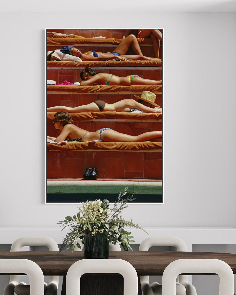 Dining room with a large painting of people in a pool on the wall.