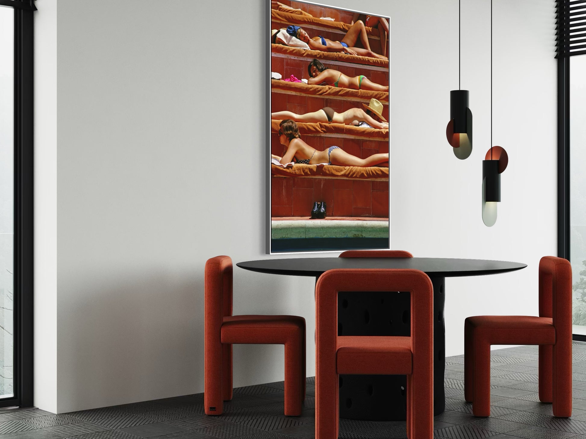 Modern dining area with red chairs and a round table, featuring a large mirror on the wall.