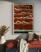 Framed artwork of people sunbathing on a wall above a sofa.