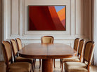 Dining room with wooden table and chairs, abstract art on the wall.