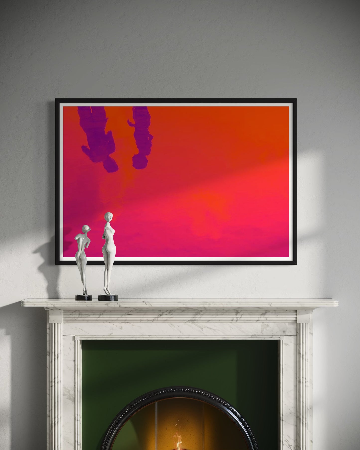 Framed abstract artwork on a wall above a fireplace with decorative figurines.