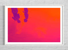 Framed artwork with a pink and orange gradient background and silhouettes of two people.
