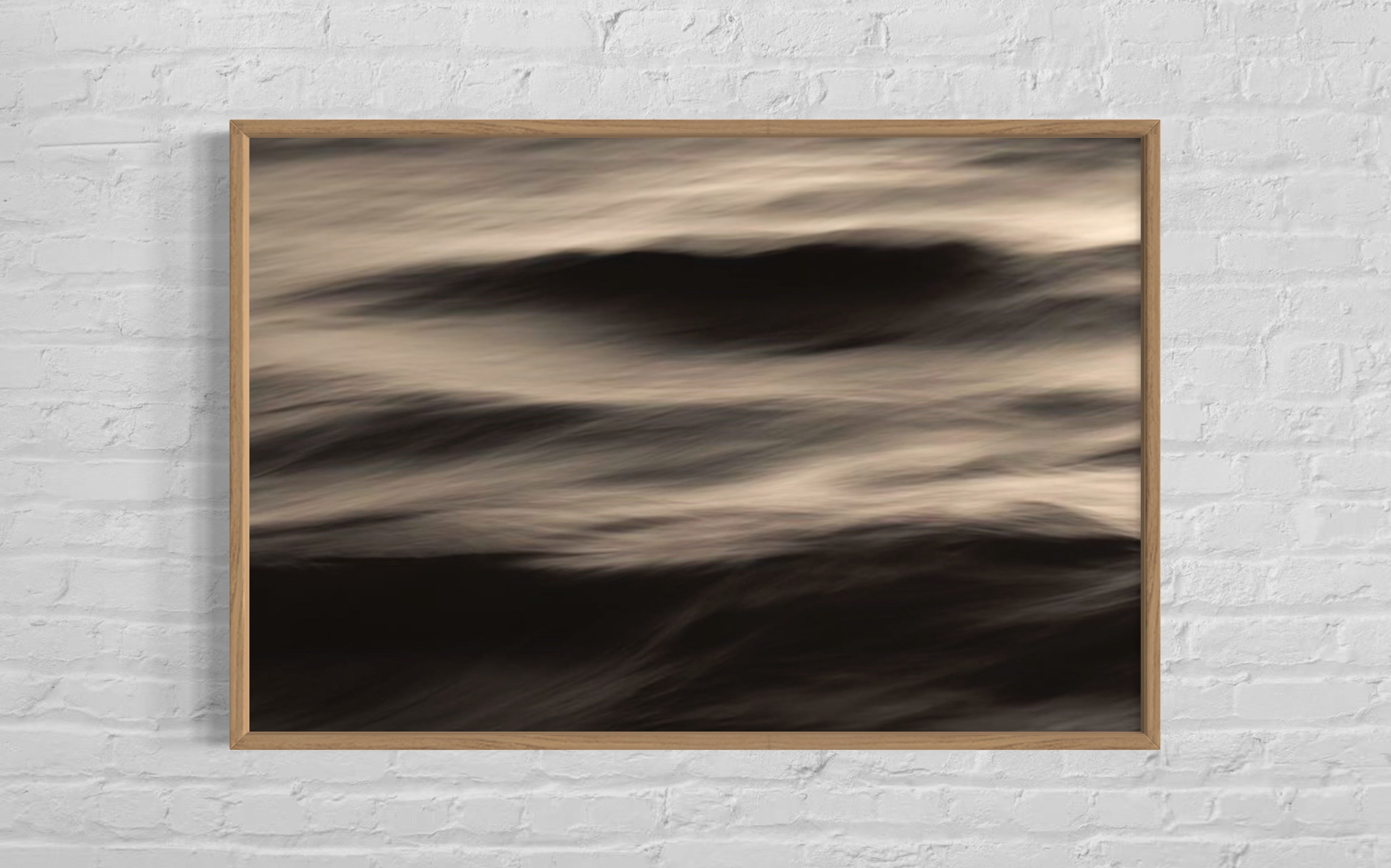 Framed abstract artwork on a white brick wall