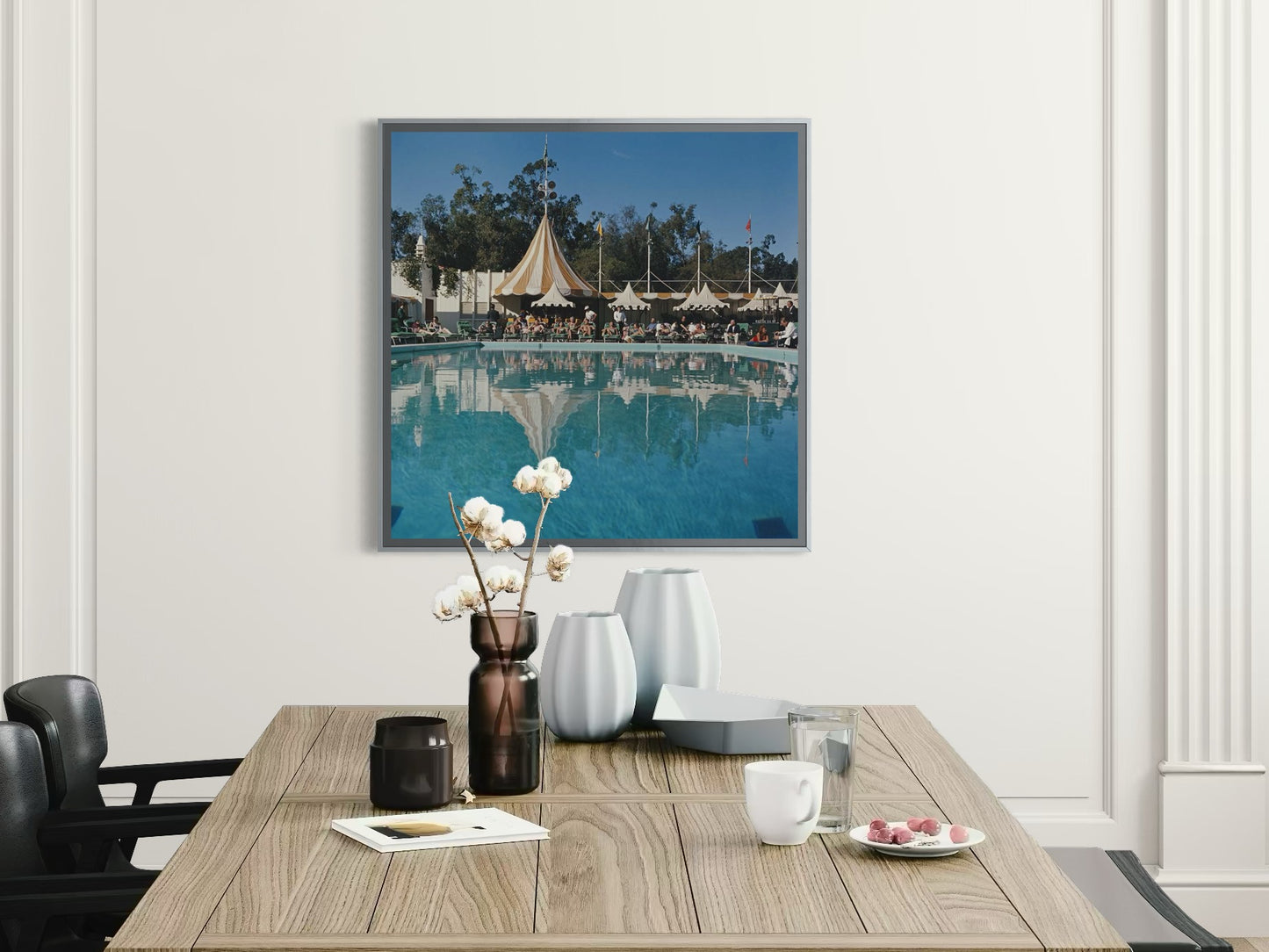 Framed artwork above a dining table with decor items.