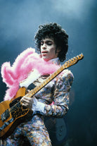 Prince Live at The Forum by Michael Ochs Archives, vibrant concert photograph of Prince performing in pink feathers and sequins, fine art print framed by The Picturalist