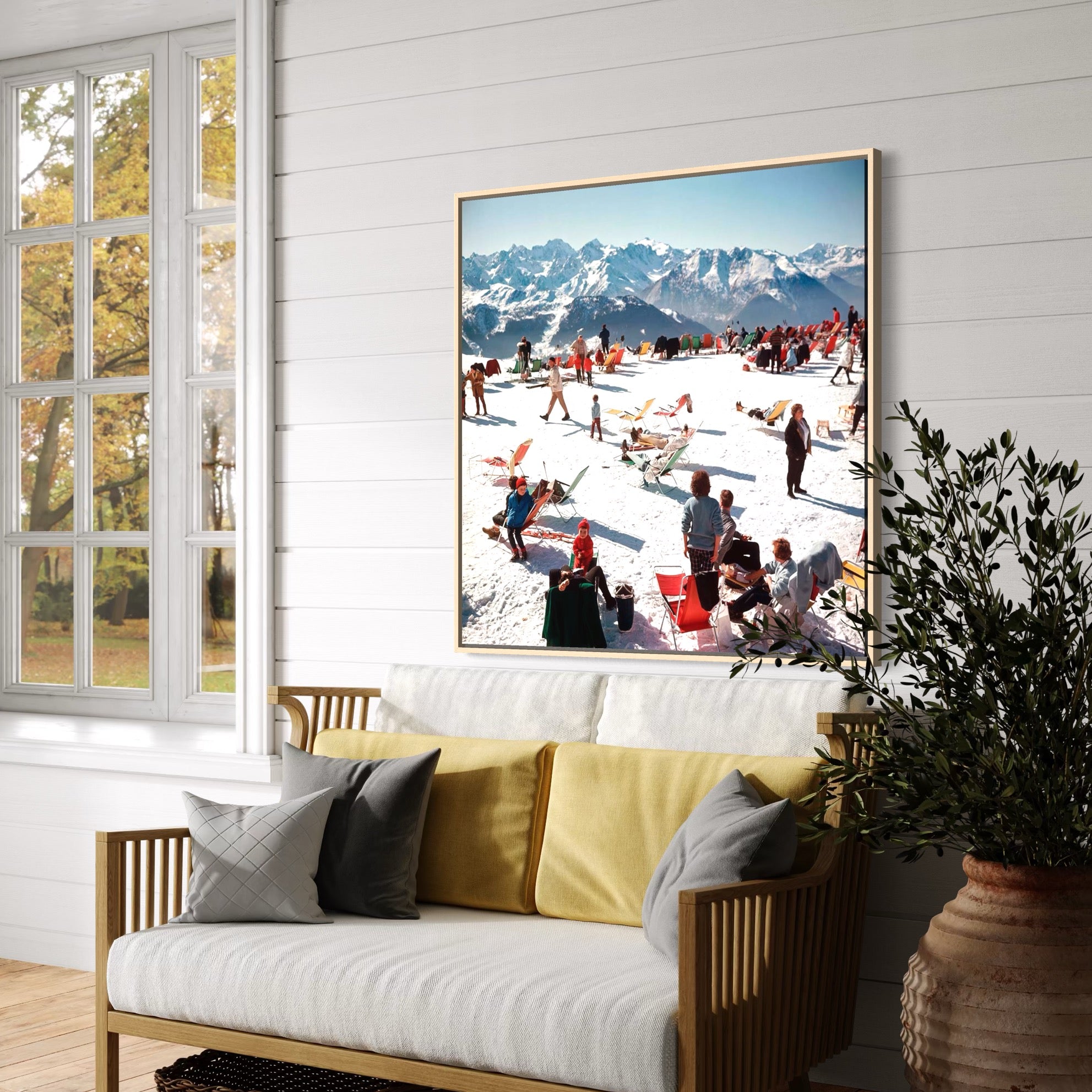 Living room with a large framed picture of a snowy mountain scene, white walls, and a wooden floor.
