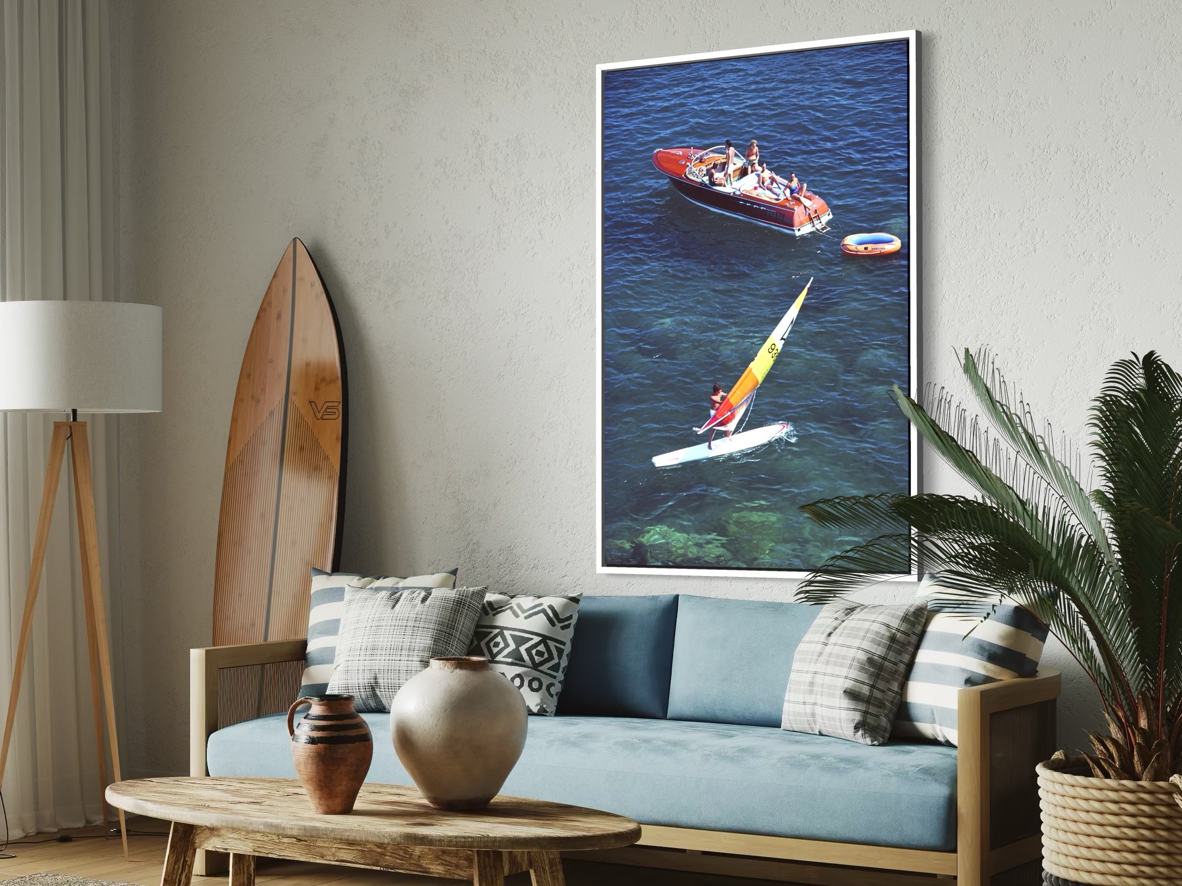 Living room with a couch, coffee table, and wall art of a kayaker and boat.